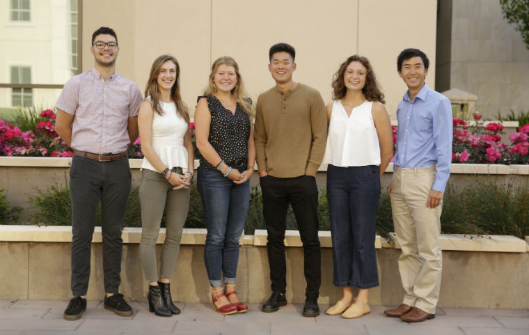 Six student Fulbright and Coro award winners posting near Charney Hall