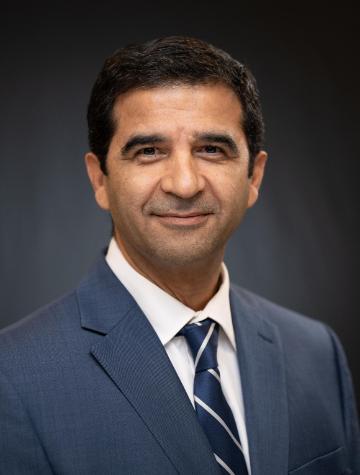 Professor Mohammad Ayoubi in a blue suit and tie.