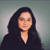 Tejaswini Edupuganti headshot against a neutral background.