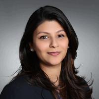 A person in formal attire posing for a headshot.