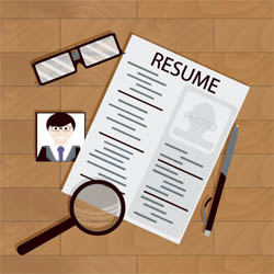Resume layout with photo, glasses, pen, and magnifying glass on a wooden surface.
