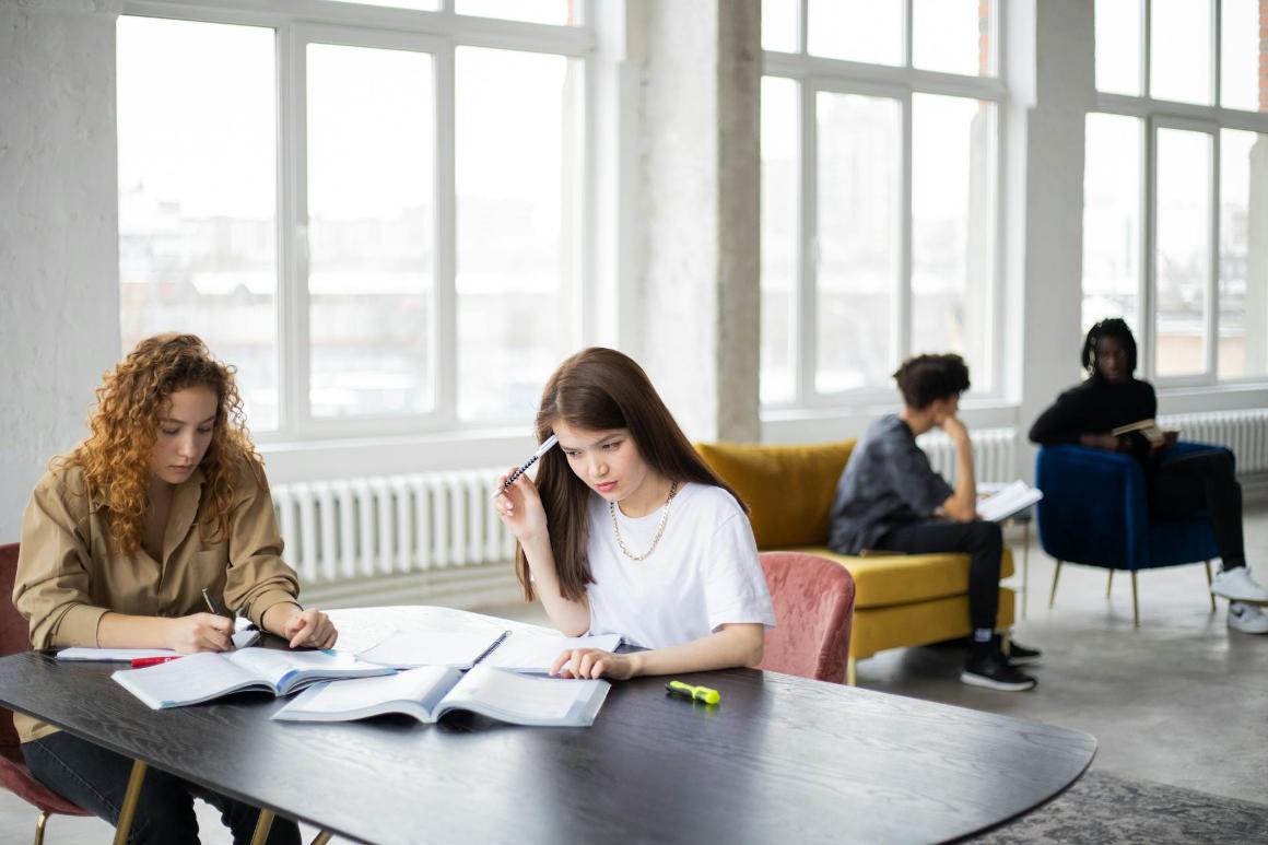 Graduate business students studying textbooks
