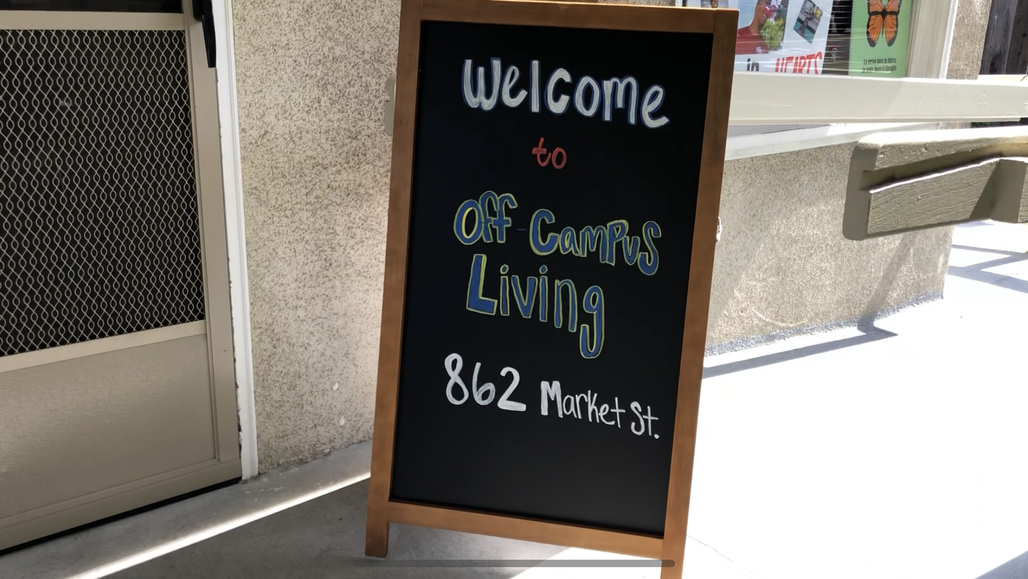 A chalkboard sign outside reads Welcome Our Garden Happy Planting.