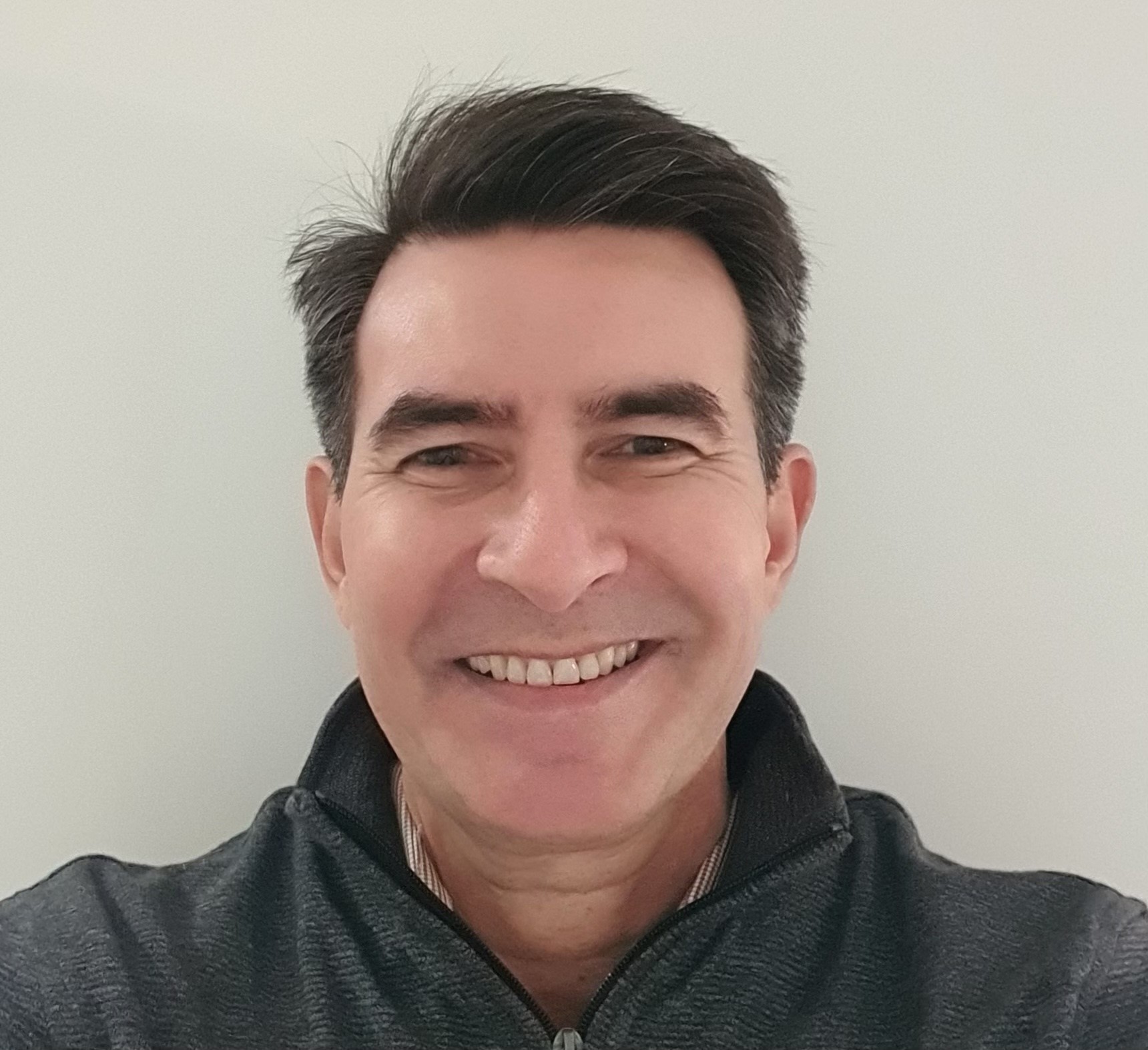 Image of man smiling with short dark hair